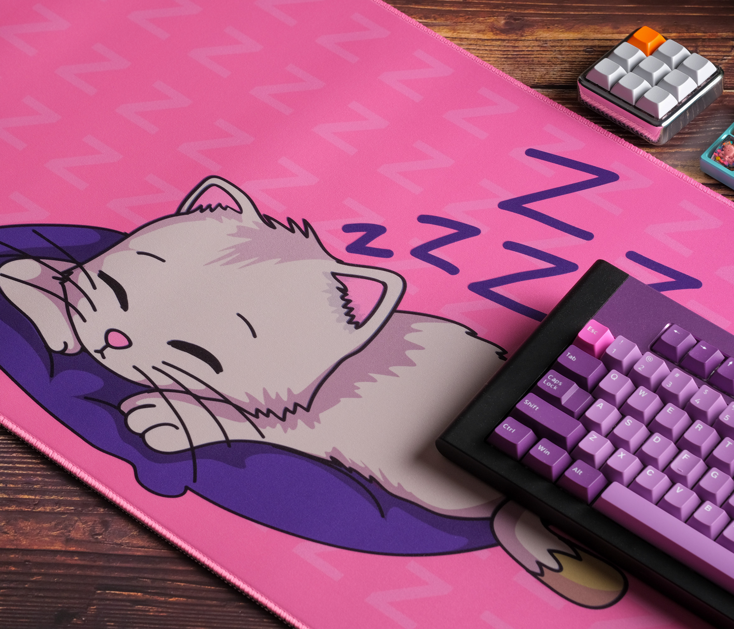 Pink desk mat with sleeping kitten cartoon and ZZZ pattern, rounded stitched edges