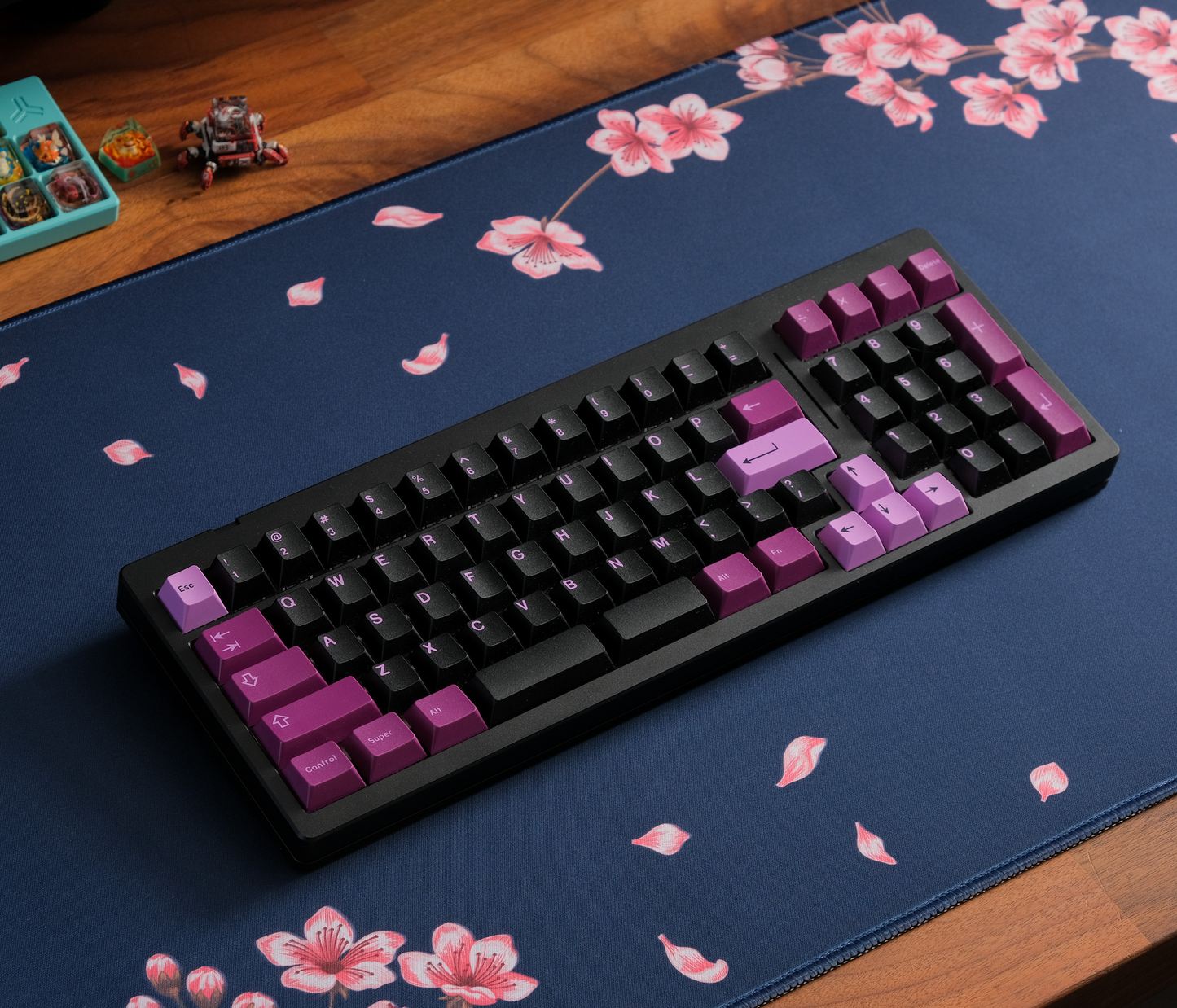 Navy desk mat with pink blossoms and small leaf prints; stitched border