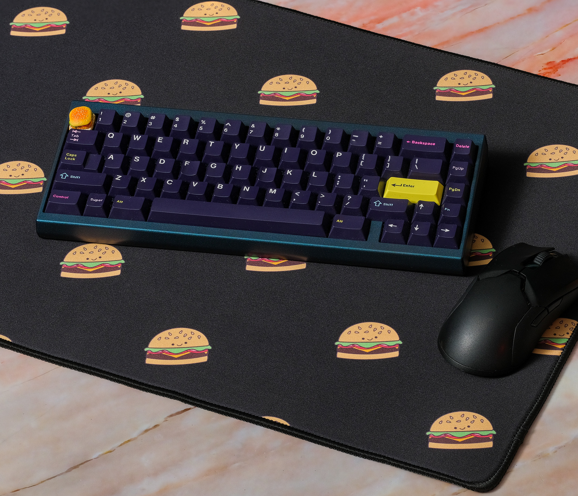 Burger-printed desk mat with blue keyboard and mouse on top