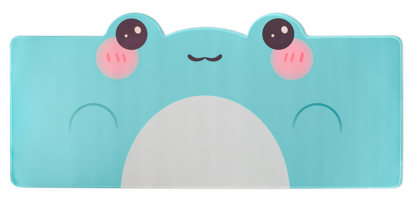 Turquoise frog-themed desk mat with white belly and pink cheek blush faces on top edge
