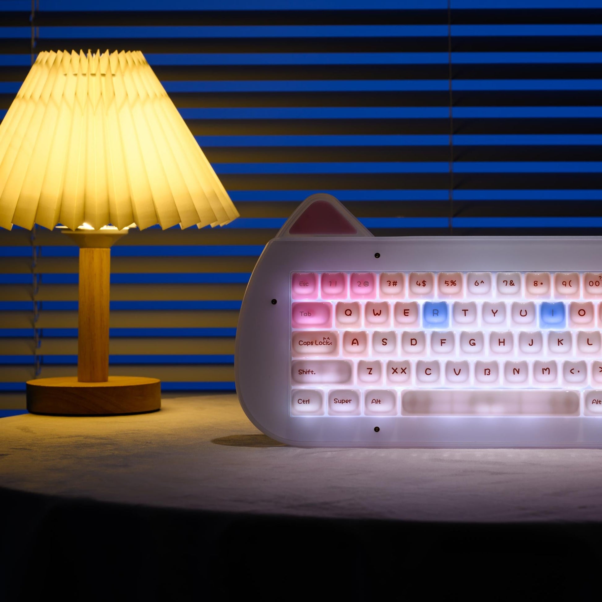 Pink and white acrylic mechanical keyboard with rainbow backlit cat-themed keycaps