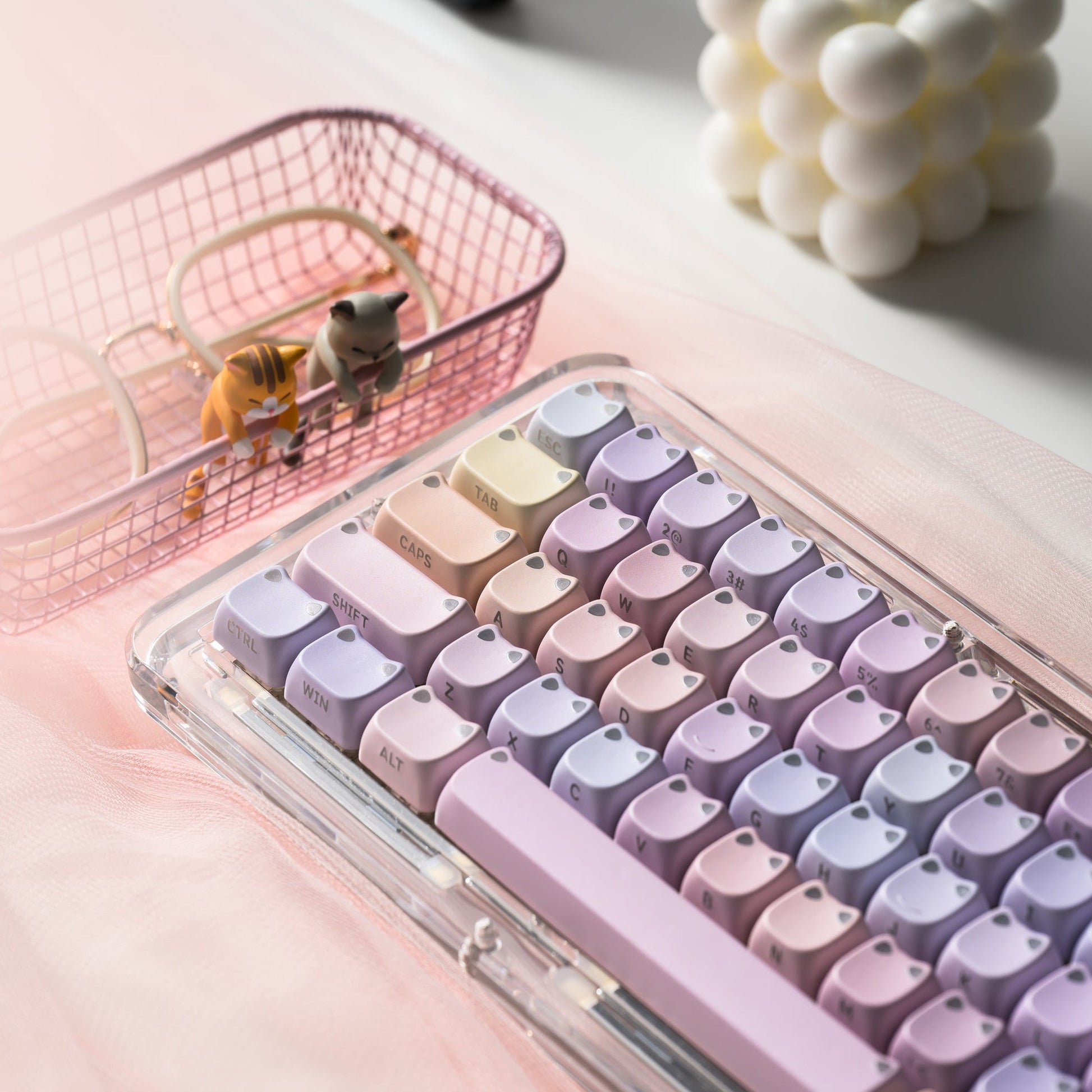 MAO profile keycap set with lilac and cream keys, shown in a clear container