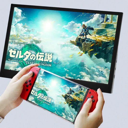 Portable black 11.6-inch LCD monitor showing a game screen held in hands
