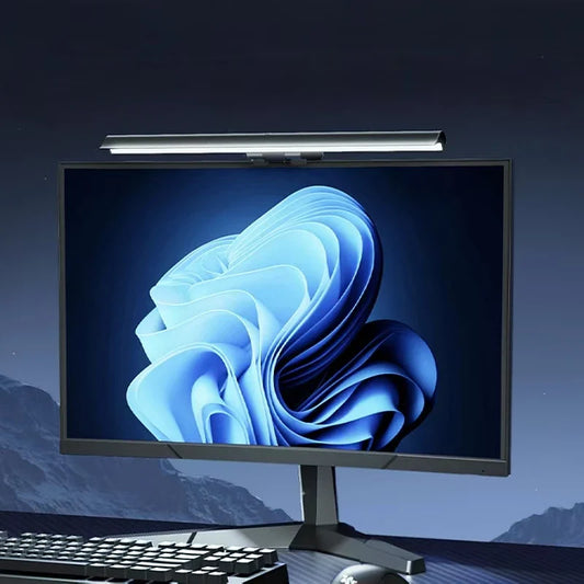 LED monitor light bar on top of a desktop monitor, thin strip with bright white glow