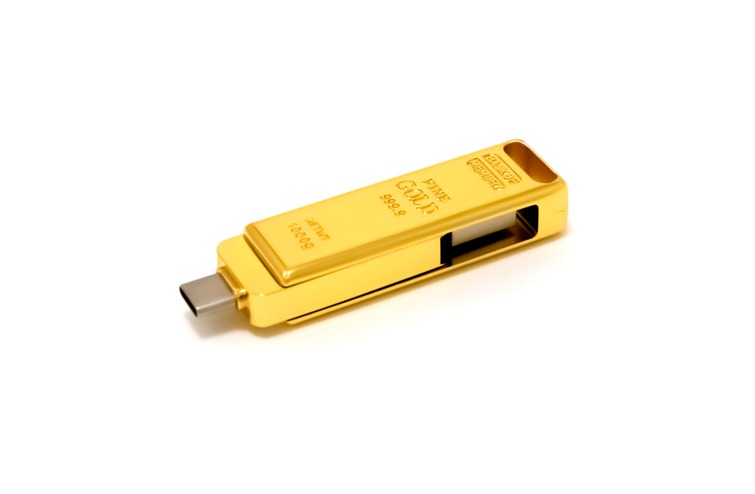 Gold USB flash drive, side view with retractable-style black slot on the casing.