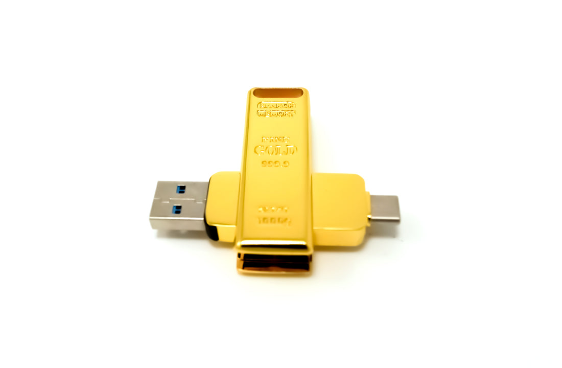Gold USB flash drive with USB-A plug front and secondary connector port on body.