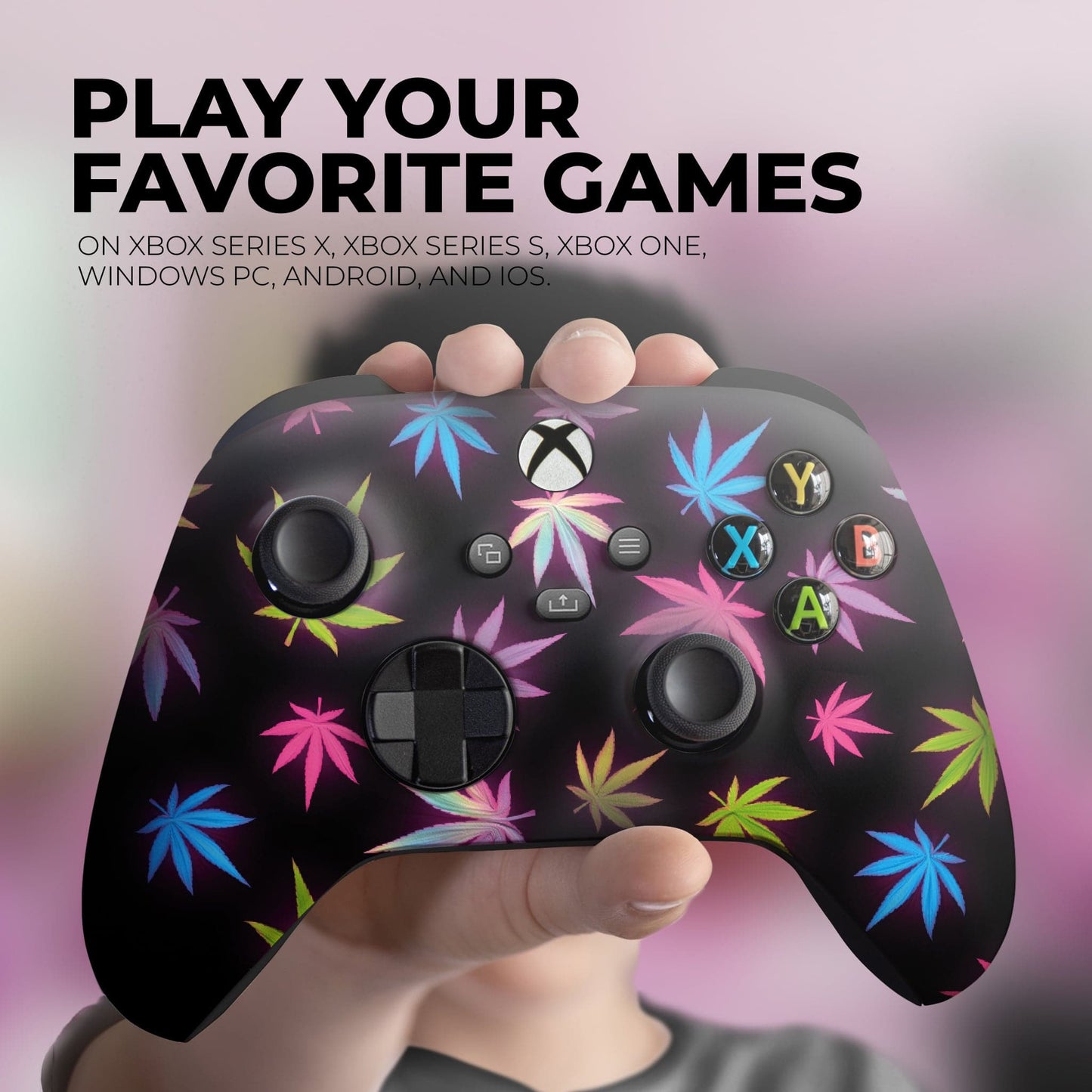 Black Xbox controller with neon cannabis leaf pattern, held in a hand