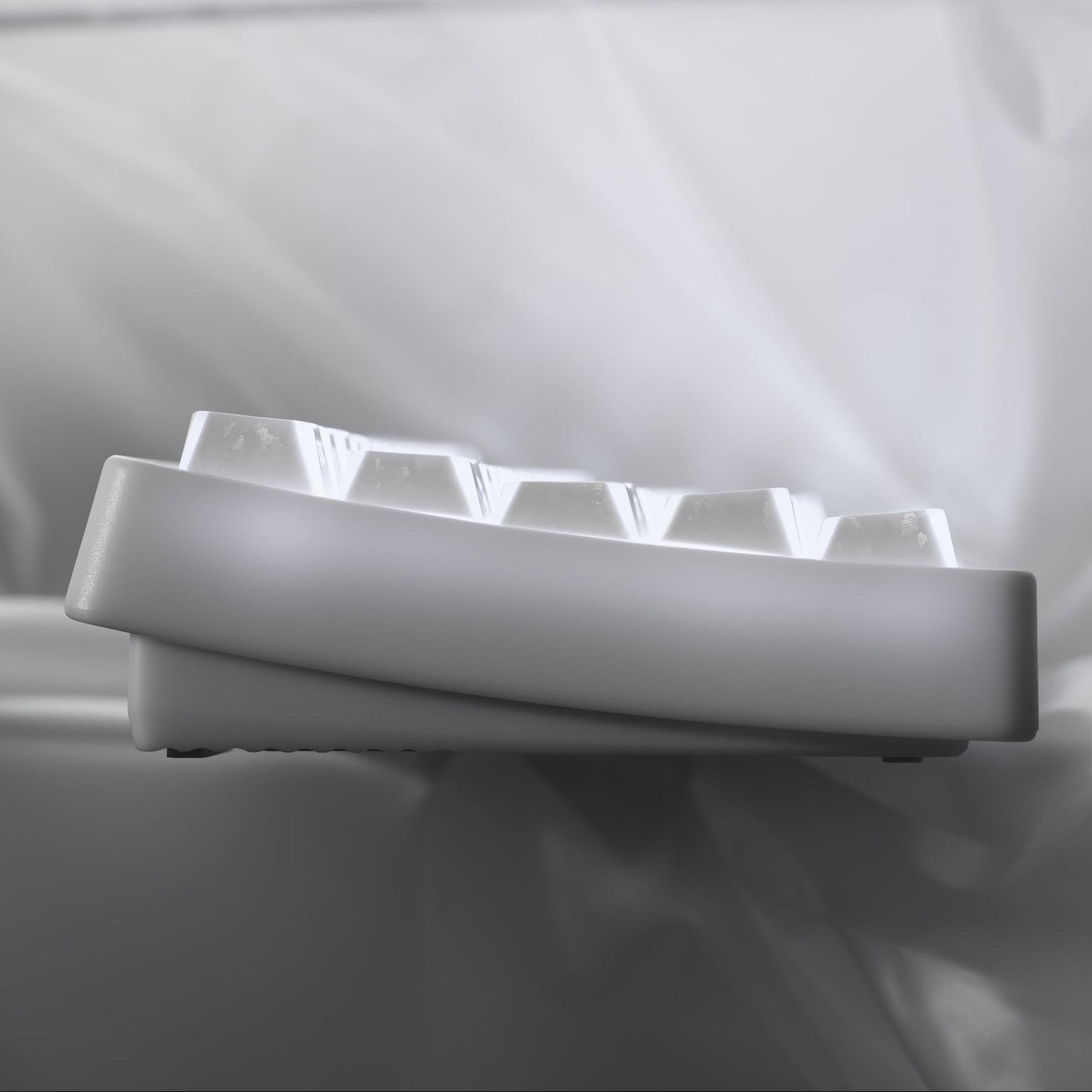 Side view of white shine-through cherry-profile keycaps on a keyboard