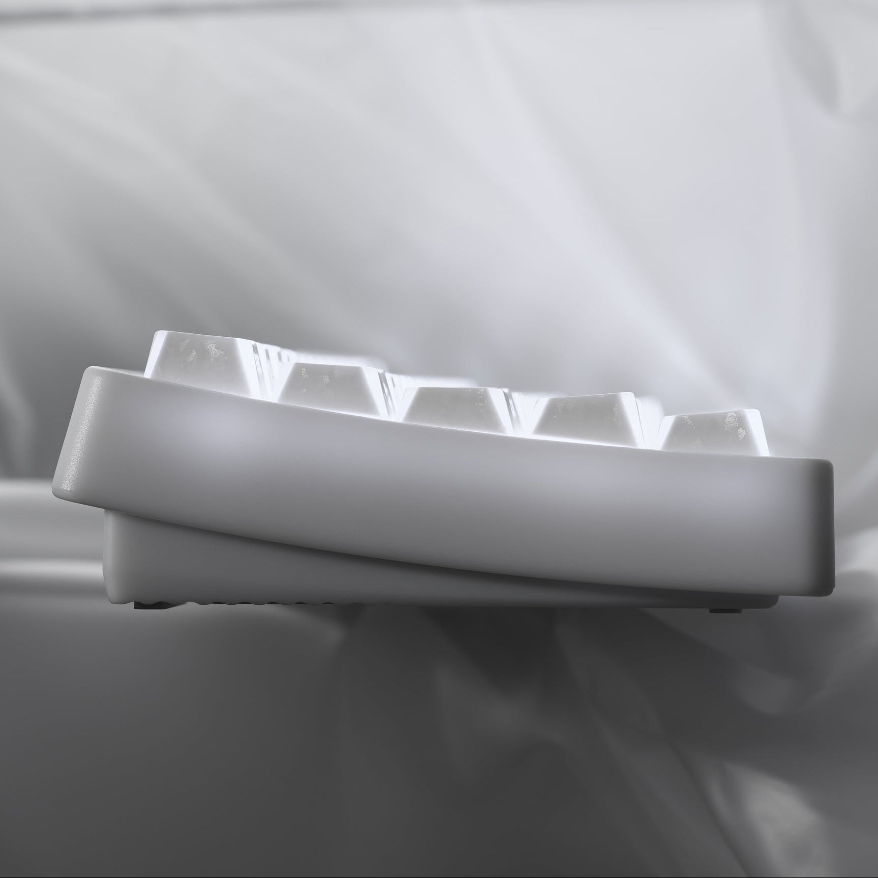 Side view of white shine-through cherry-profile keycaps on a keyboard