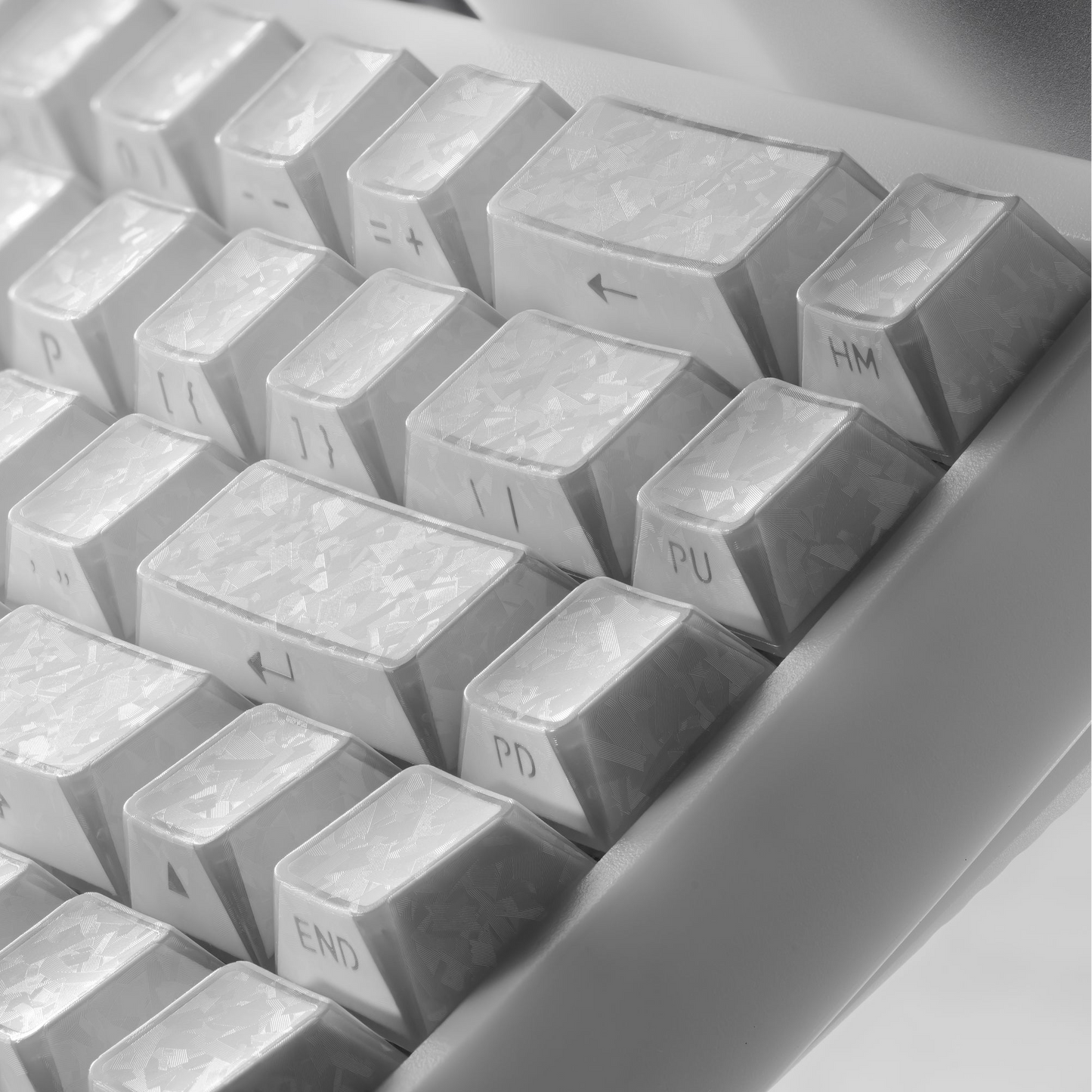 Gray shine-through cherry-profile keycaps with sculpted letters and textured tops