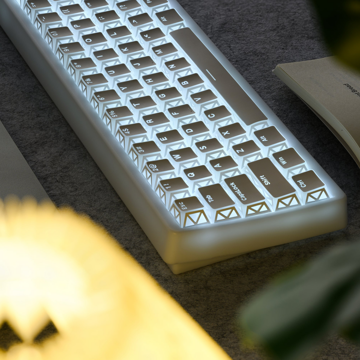 White PBT keycaps glowing cyan with prism-style legend icons across the board