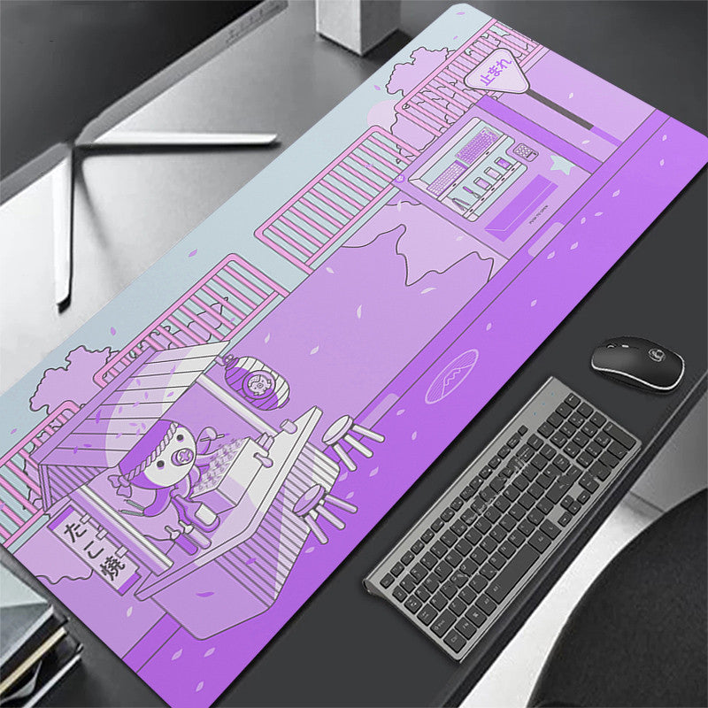Purple desk mat with cartoon design on a desk with keyboard and octopus.