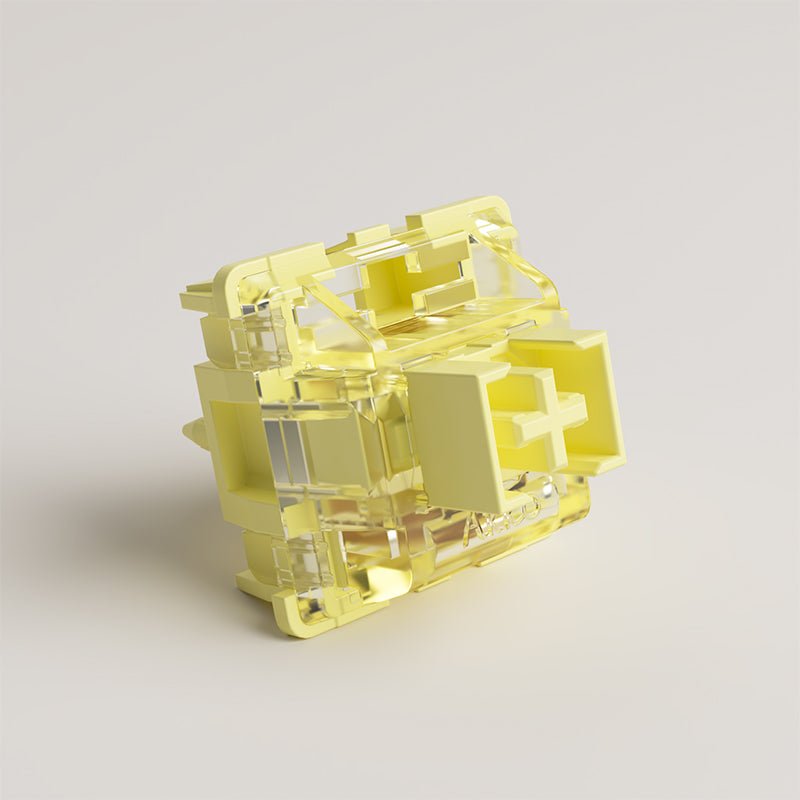 Cream yellow mechanical switch with clear housing, close side view