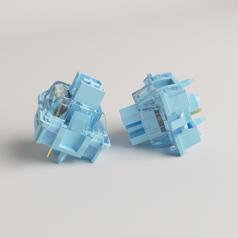 Pair of light blue mechanical keyboard switches with transparent stems and pins
