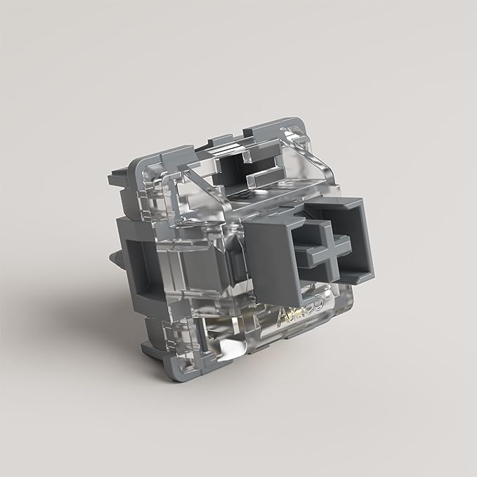 Mechanical keyboard switch with clear internal parts and dark gray base, side view