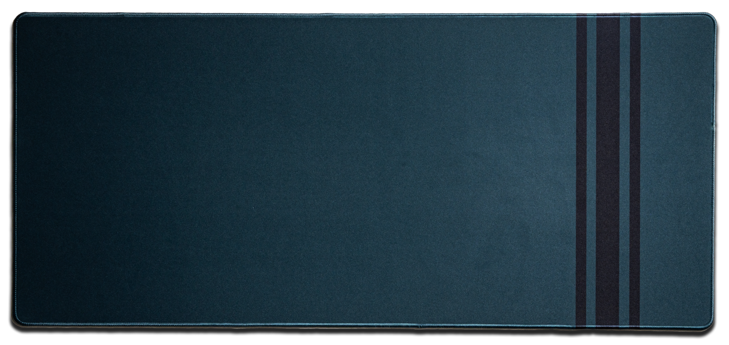 Dark blue desk mat with stitched edges and three vertical stripe accents