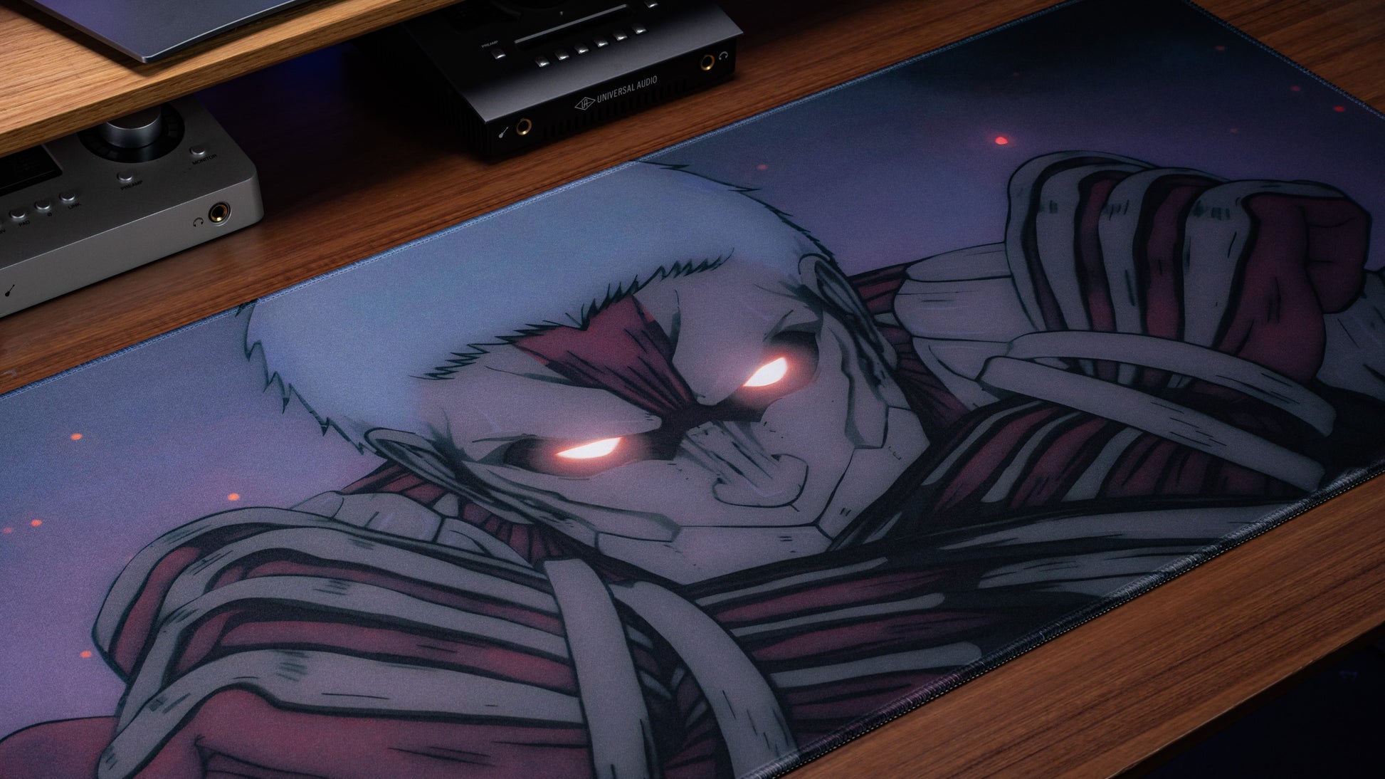 Anime desk mat close-up of character lying, with glowing red eyes illustration
