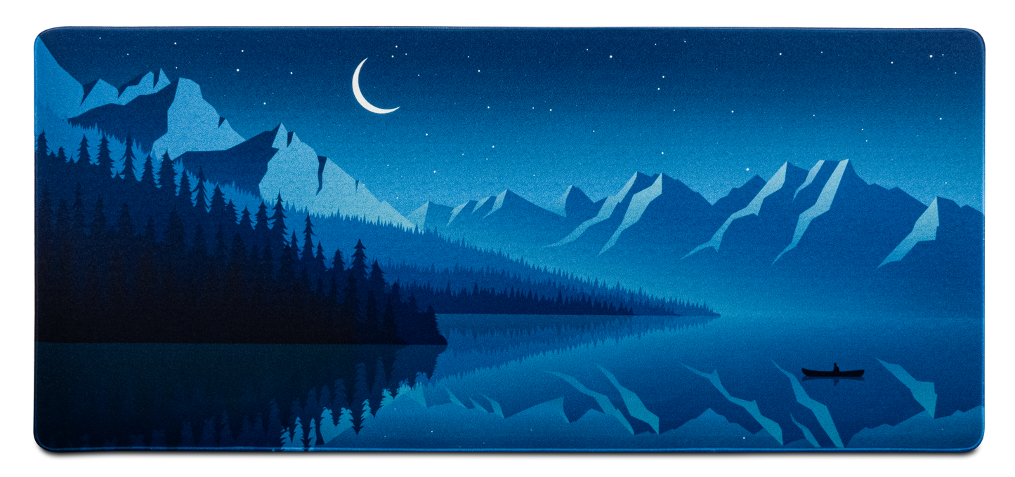 Alberta V2 desk mat with deep blue night sky, moon, pine forest and mountains