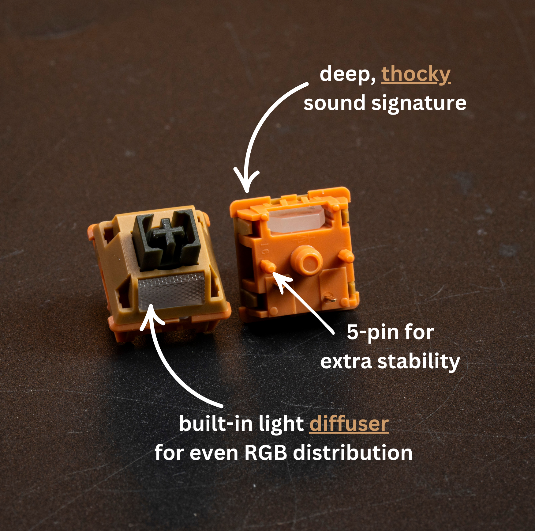 Two mechanical linear switches, one tan and one orange, with visible stem and pins