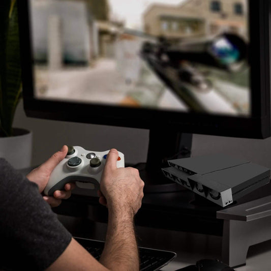 Gaming console cooling fan, black unit with multiple vents and fans on TV stand