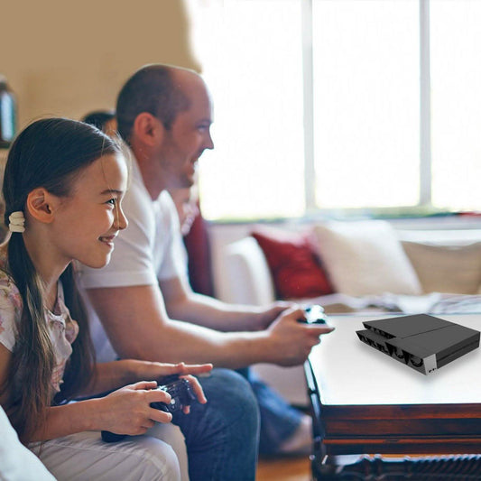 Gaming console cooling fan beside console on living room media stand, black multi-fan unit