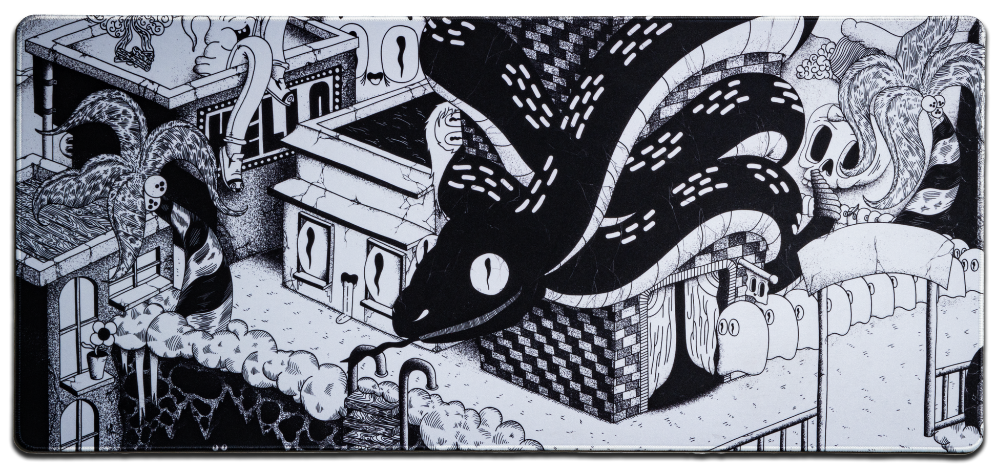 Black and white desk mat with swirling tentacle and haunted house illustration