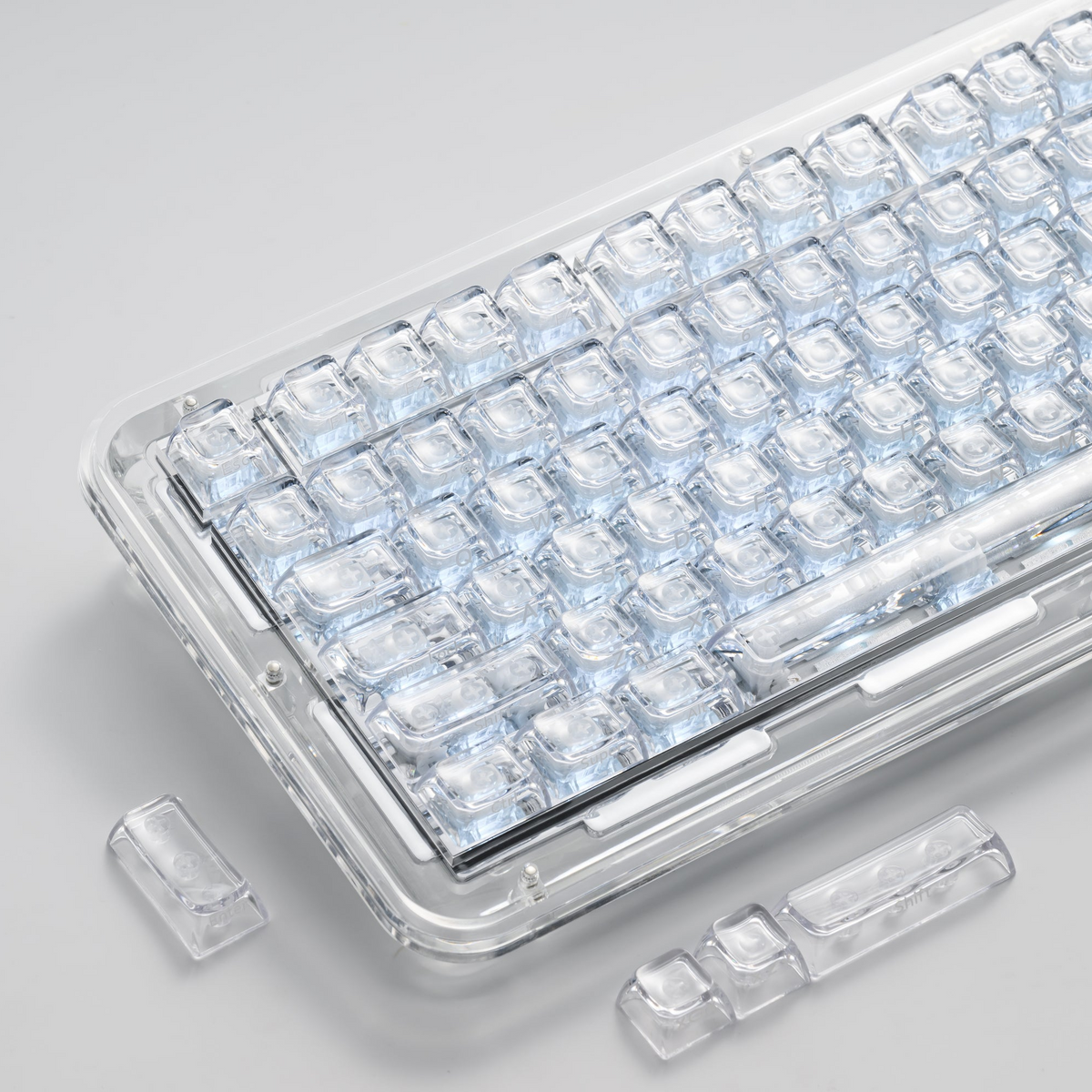 Transparent SA profile keycaps with clear legends arranged in a tray