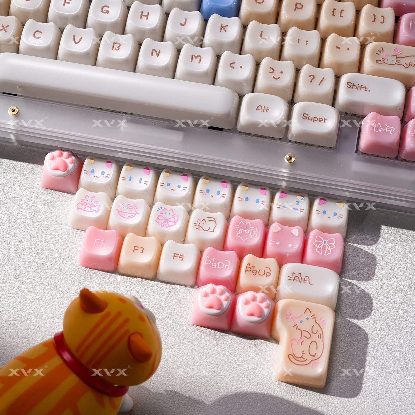 Pink and cream cat paw keycaps with printed legends on a keyboard plate