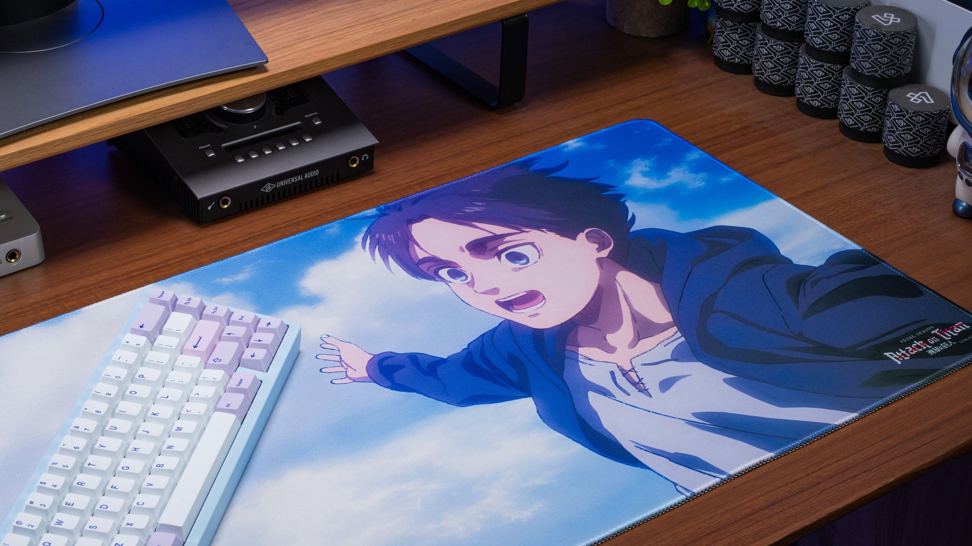 Anime desk mat with smiling boy in blue hoodie against soft cloud background