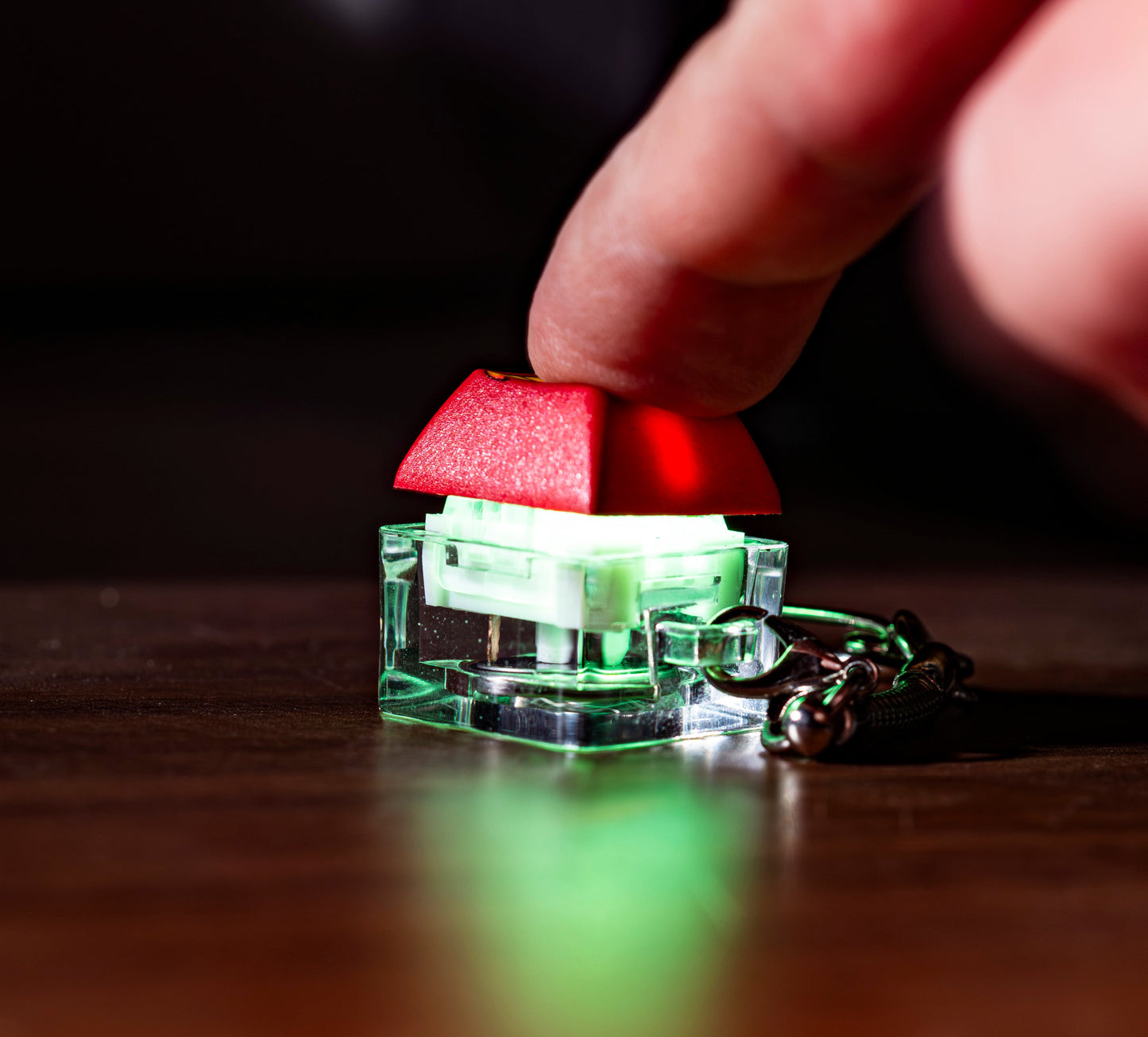 Funny keycap fidget keychain with red keycap being pressed on clear base