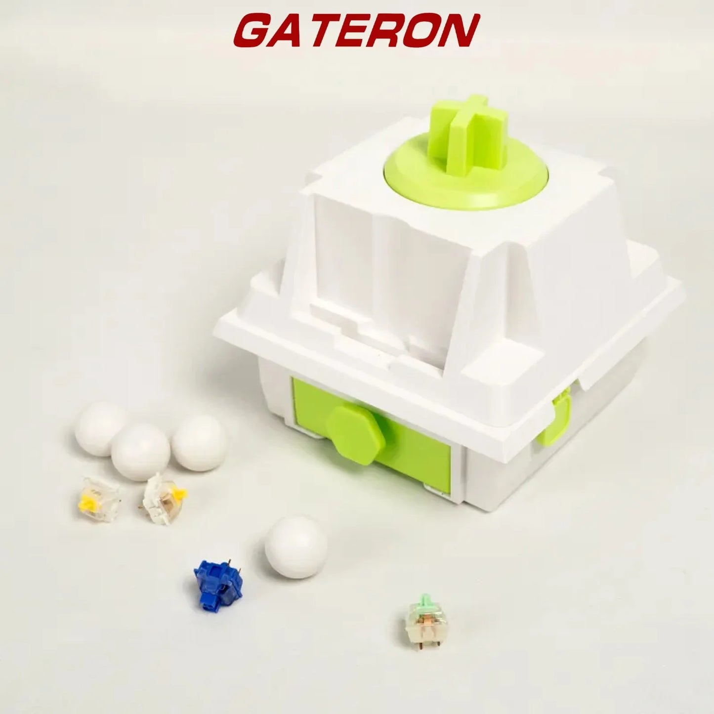 Mechanical switch with white housing and lime green stem, plus loose switch parts