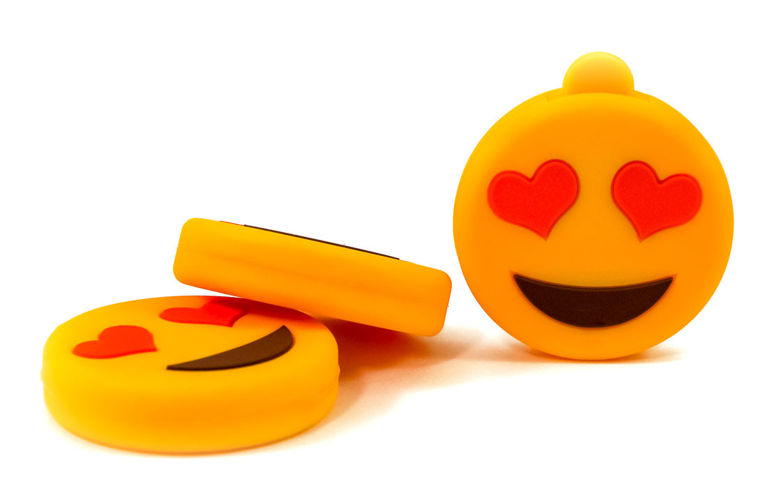 Heart-eyes emoji USB flash drive with yellow body and exposed connector plug.