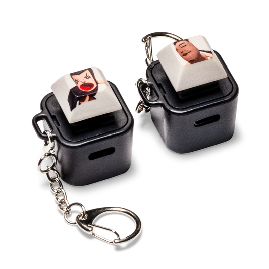 Black keycap animation fidget with face graphic, attached to metal keychain