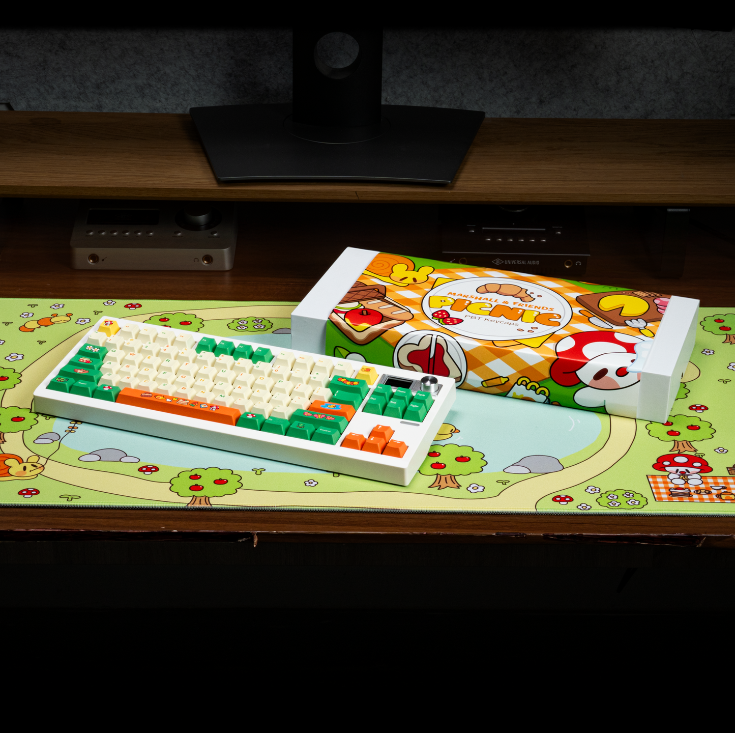 Colorful PBT keycap set on desk, cream letters with green and orange illustrated caps