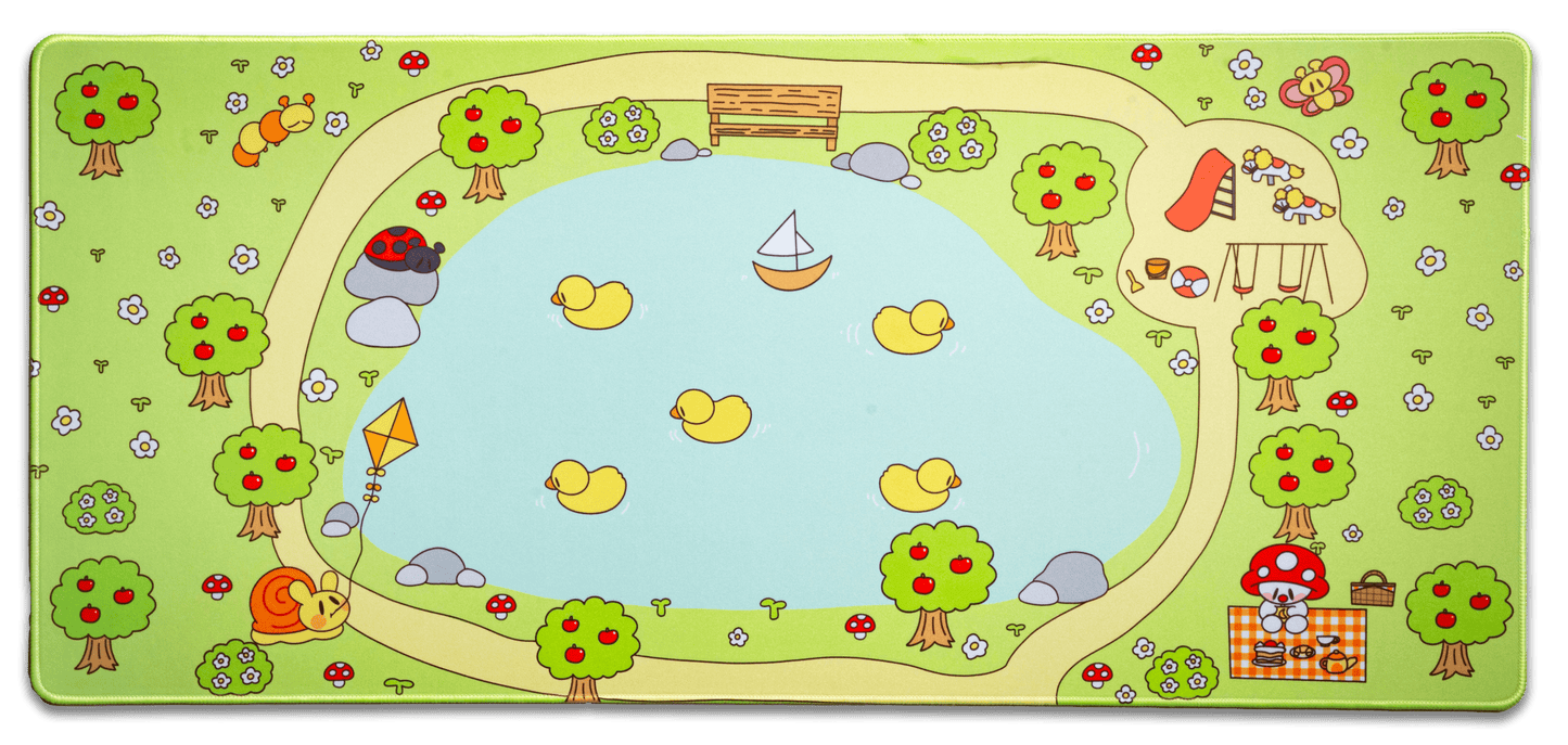 Picnic desk mat with green border and cartoon trees, mushrooms, and picnic scene
