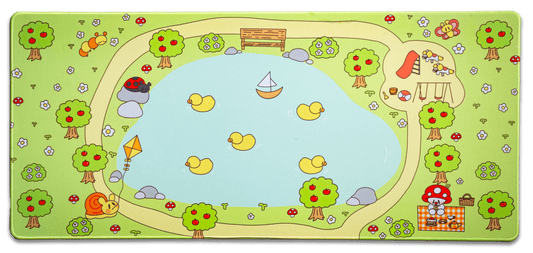 Picnic desk mat with green border and cartoon trees, mushrooms, and picnic scene