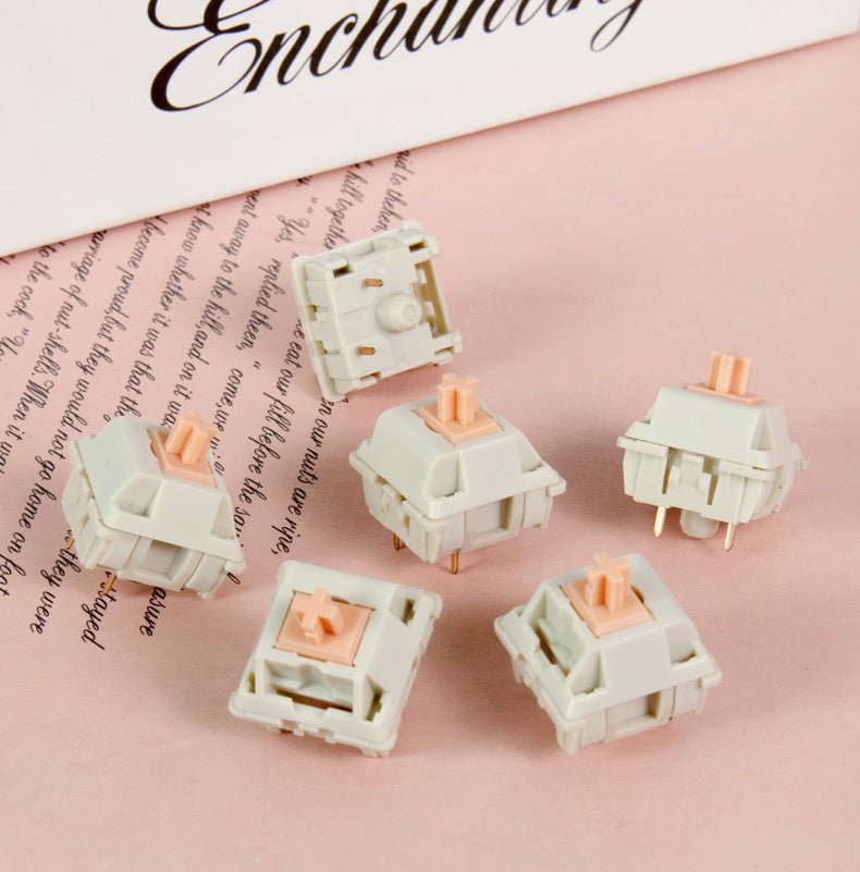 Set of MMD Holy Panda mechanical switches with peach stems in white housings