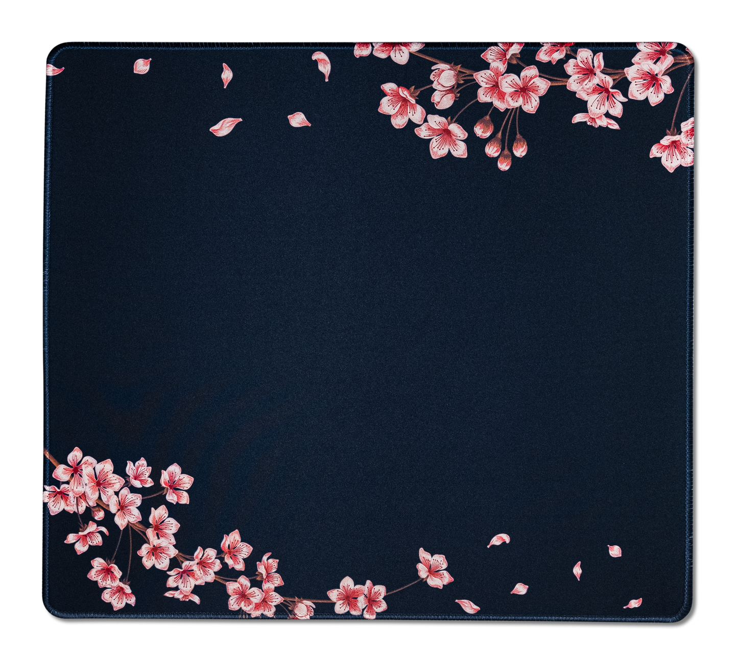Navy desk mat with pink blossom branches and leaf speckles; stitched border