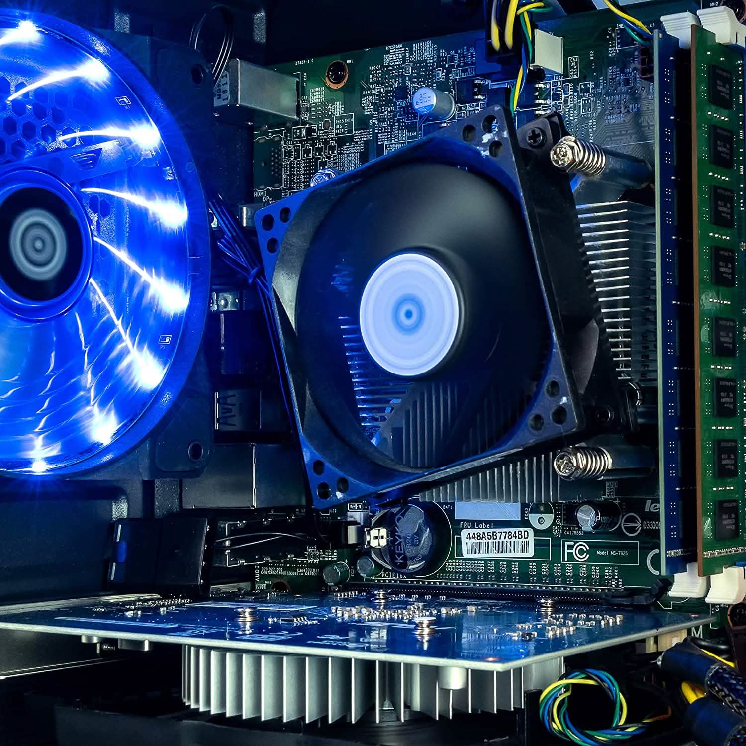 Desktop PC interior closeup of blue CPU fan and motherboard components