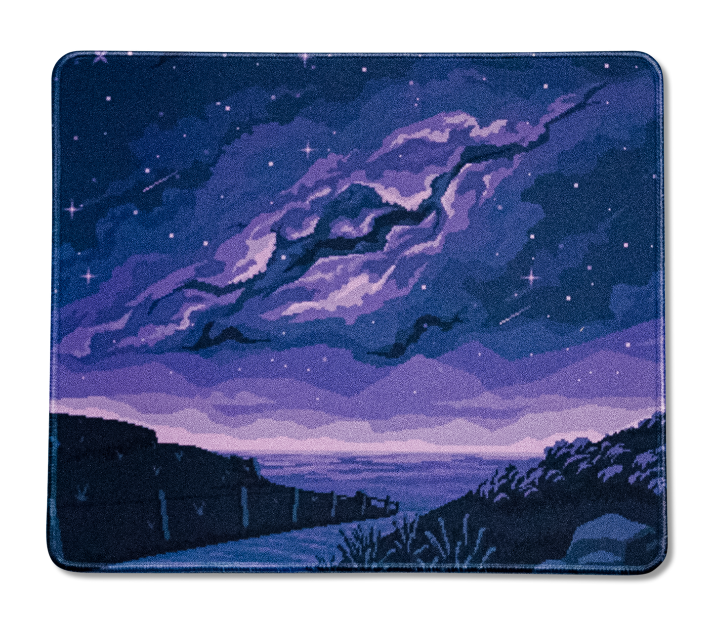 Rectangular desk mat with purple comet clouds, star speckles, and hillside view