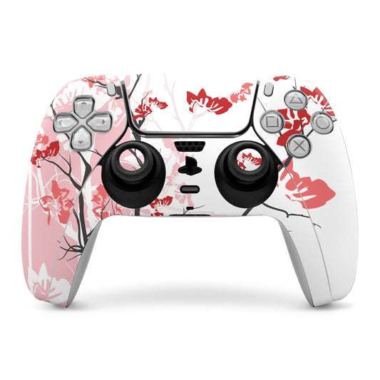 PS5 DualSense controller skin with pink and white floral pattern, red leaves, black grips