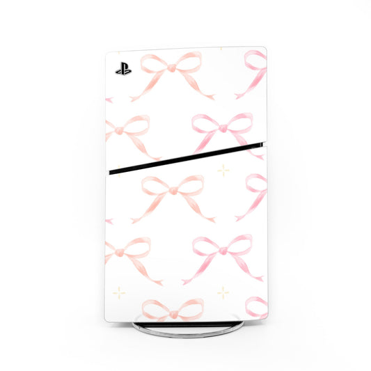 PS5 Slim console skin with pink bow pattern and black horizontal accent stripe