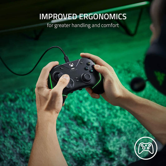 Razer wired gaming pro controller held in hands, black with green RGB light