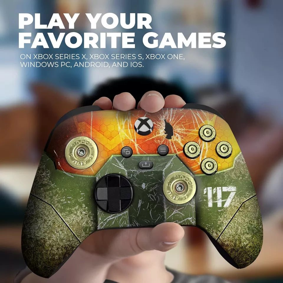 Xbox Series X controller with green camo-like print and orange top art, held in hand