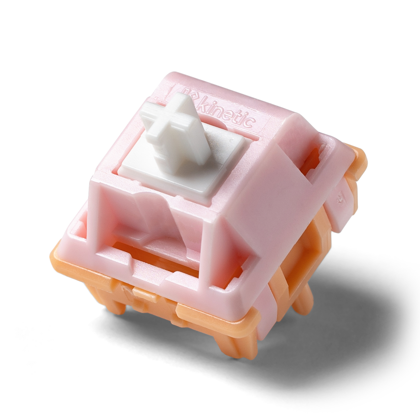Kinetic tactile switch with pink housing and white cross stem, side view