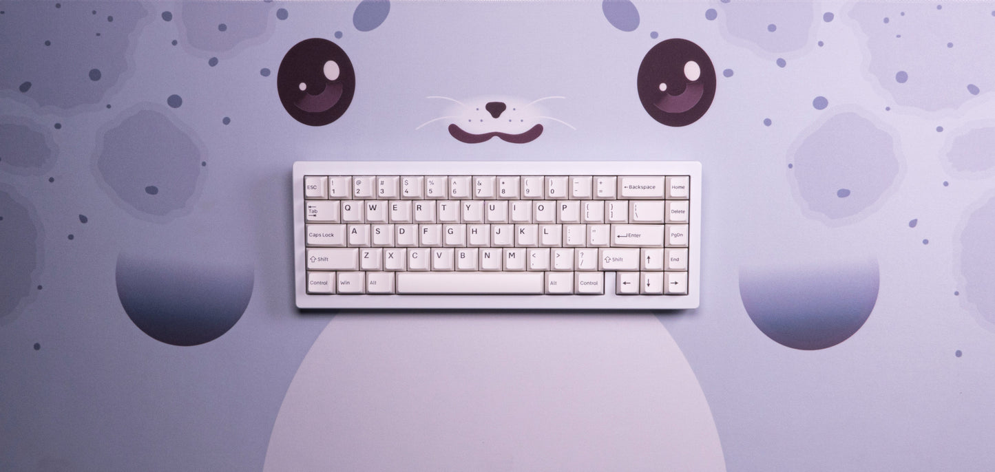 Seal-themed desk mat with keyboard centered, light blue with seal face and whiskers