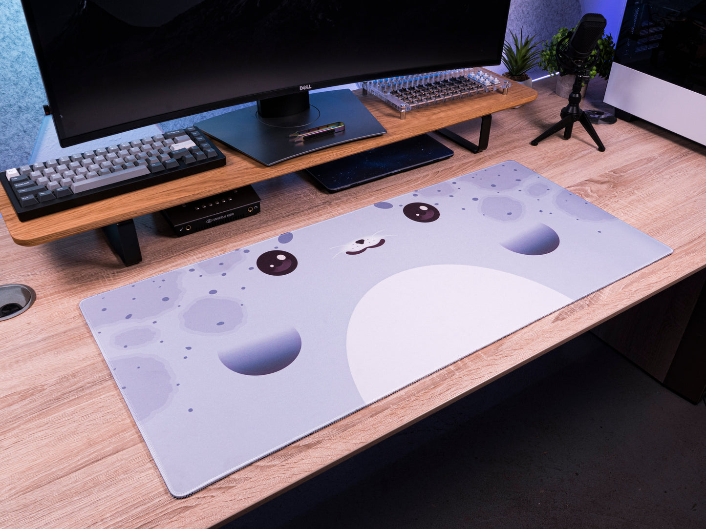 Seal-pattern desk mat on wooden desk, light blue with big seal face graphics