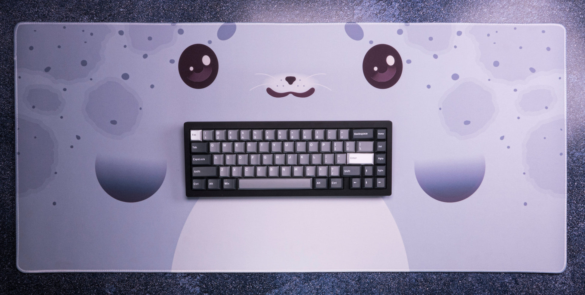 Seal-themed desk mat with keyboard centered, light blue surface with seal face