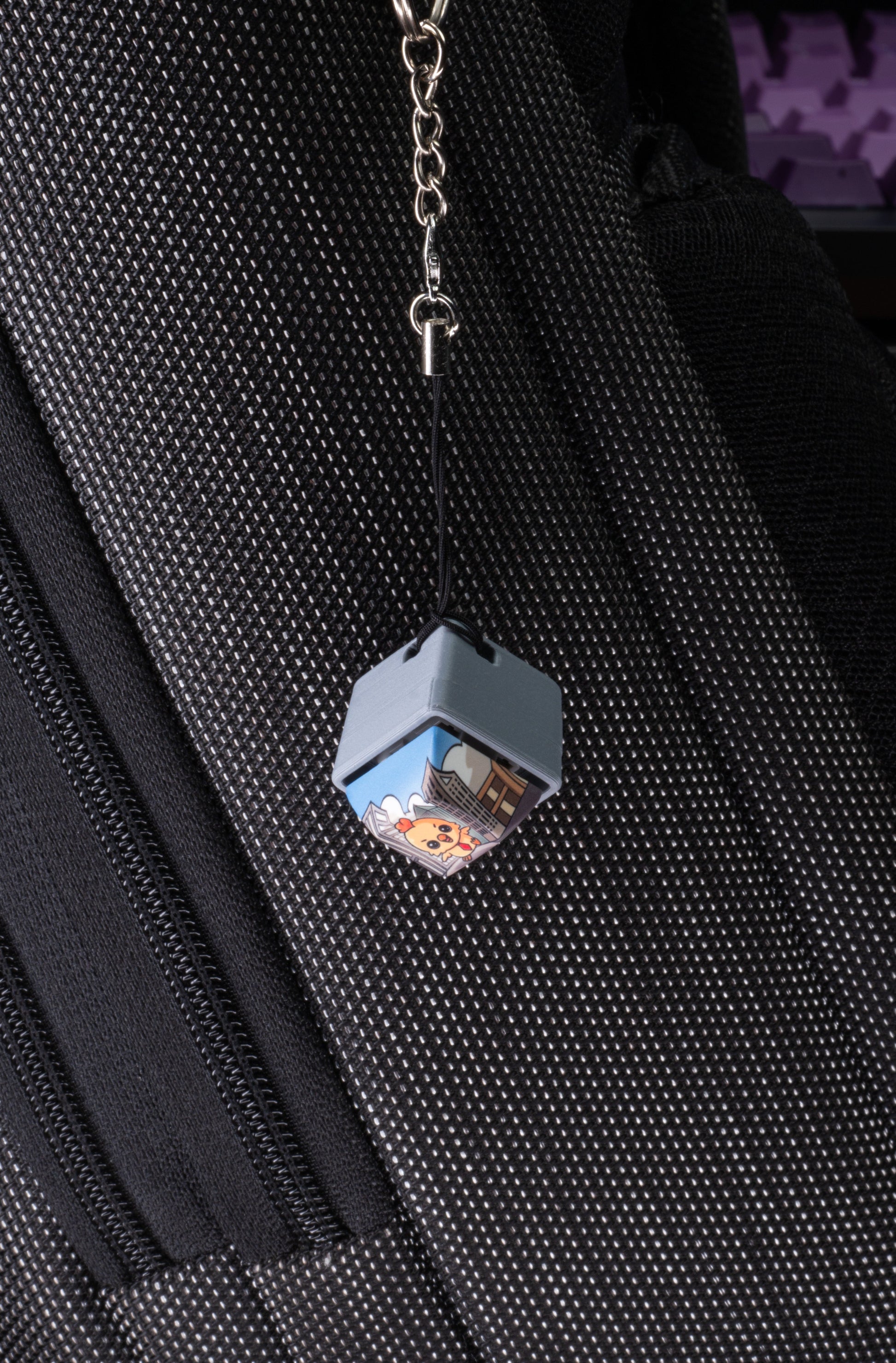 Keycap charm fidget on silver chain with cartoon Hen, attached to black zipper pull