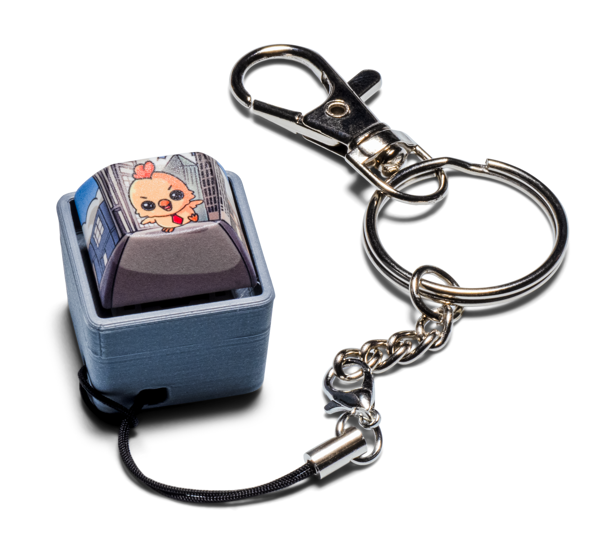 Fidget keychain with silver metal clip and chain, light blue keycap charm with cartoon art